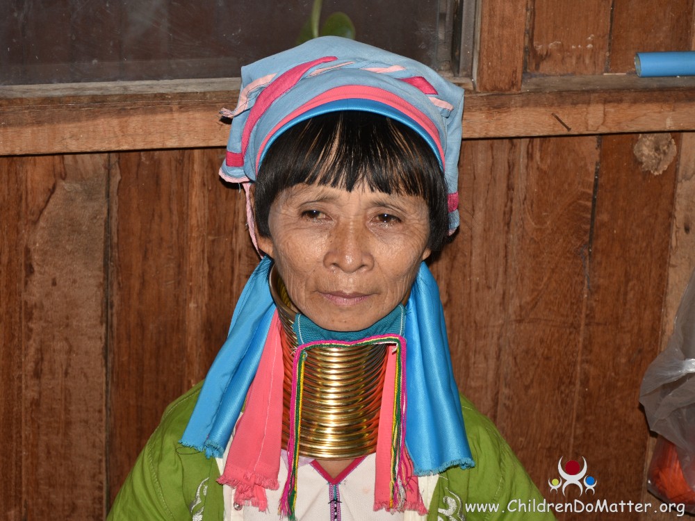 Children and women in ancient Myanmar tribe wear brass rings and